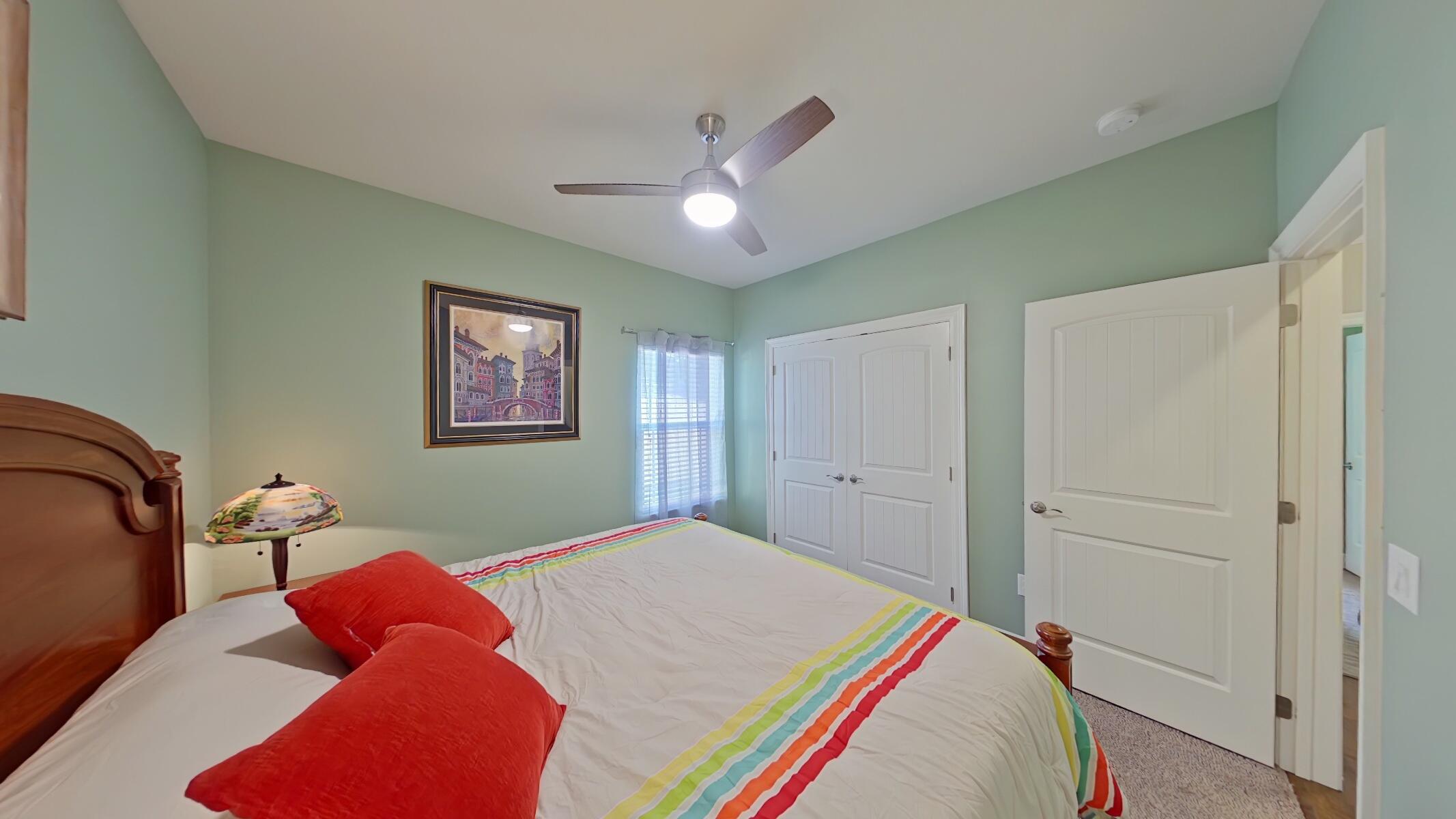 8686 El Paseo Street Navarre, FL 32566 - Photo 22 of 39 a bedroom with a bed and a chandelier