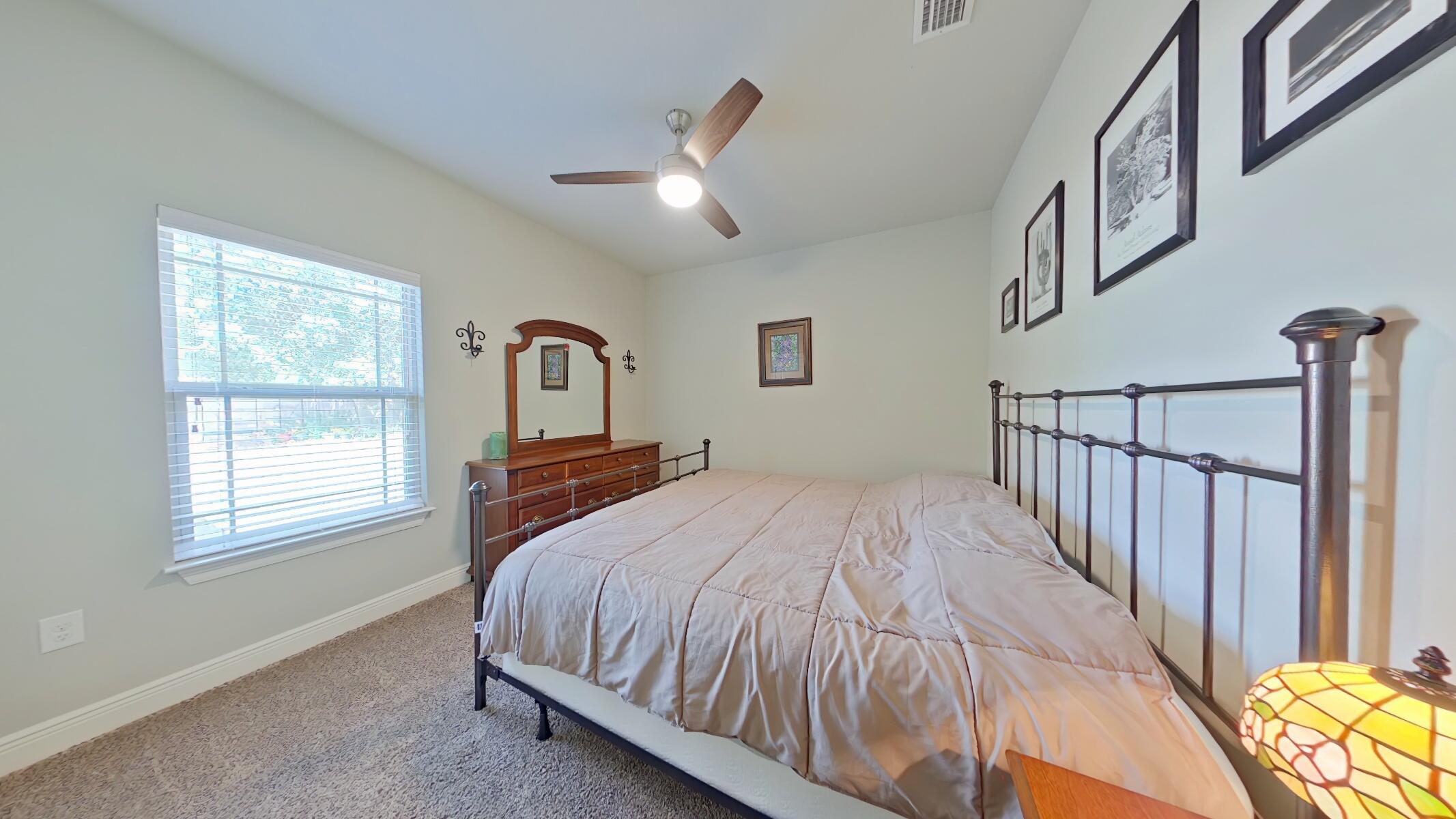 8686 El Paseo Street Navarre, FL 32566 - Photo 23 of 39 a bedroom with a bed next to a window