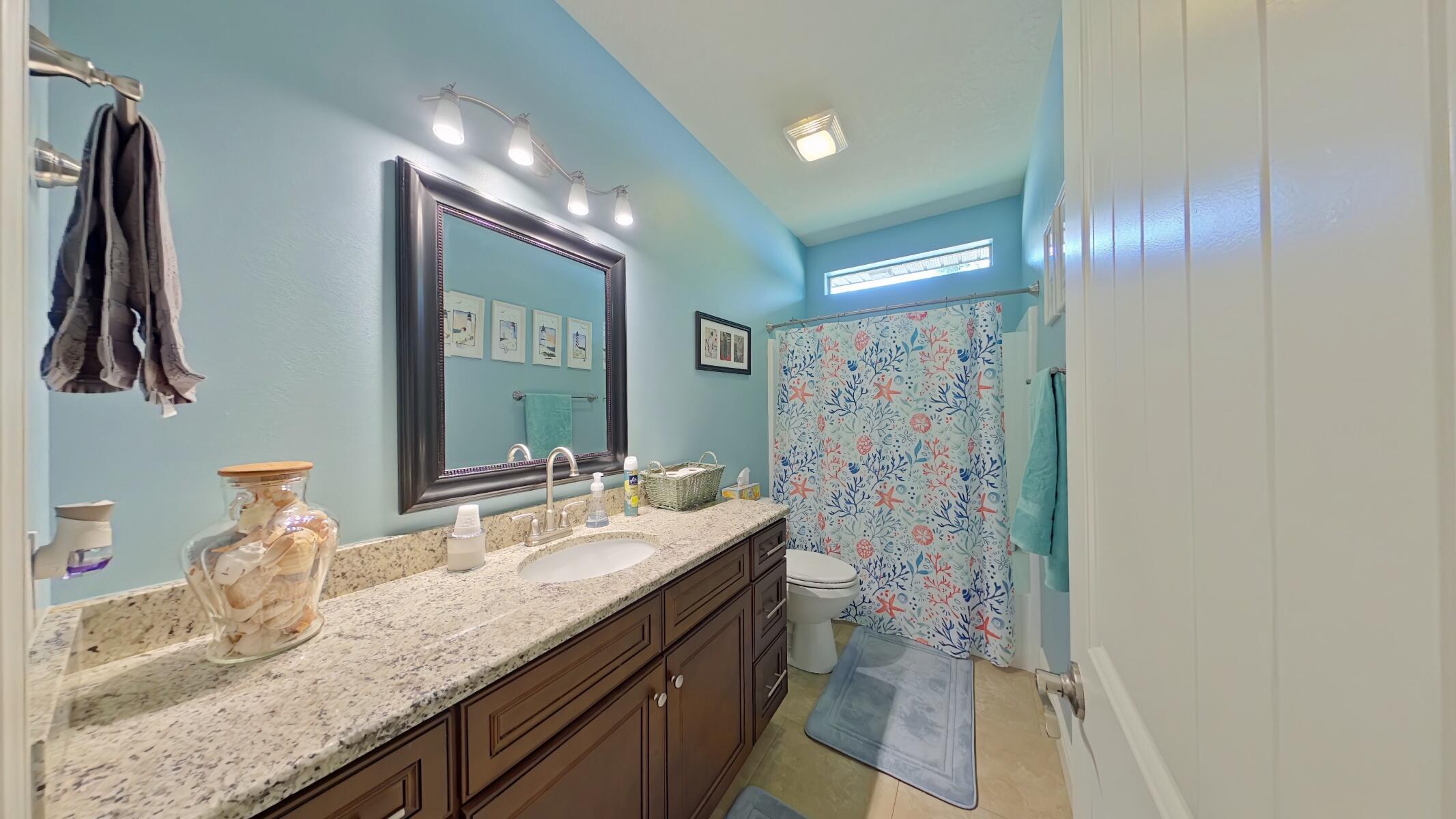 8686 El Paseo Street Navarre, FL 32566 - Photo 25 of 39 a bathroom with double vanity and a mirror
