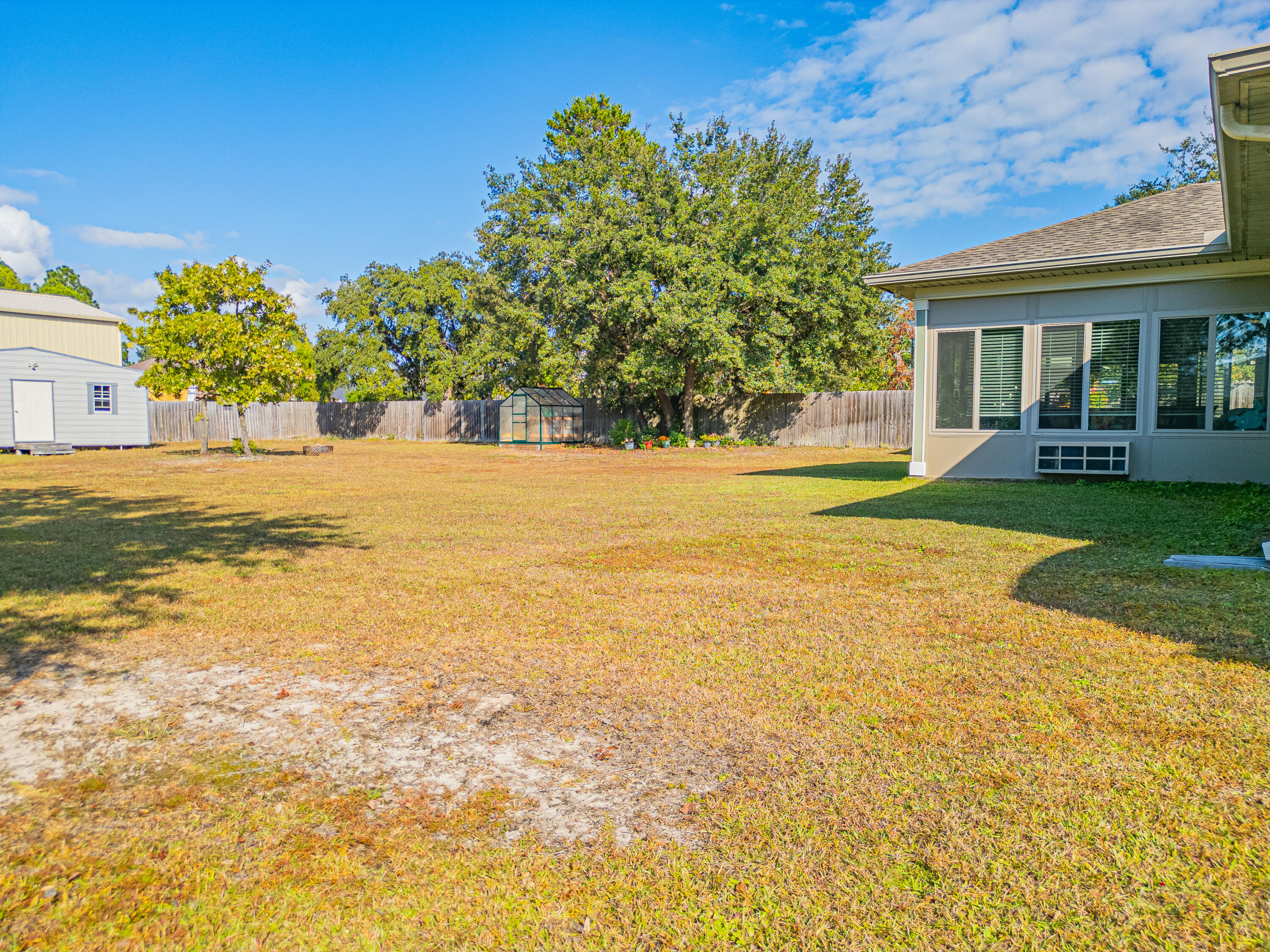 8686 El Paseo Street Navarre, FL 32566 - Photo 30 of 39 a view of an swimming pool with a yard