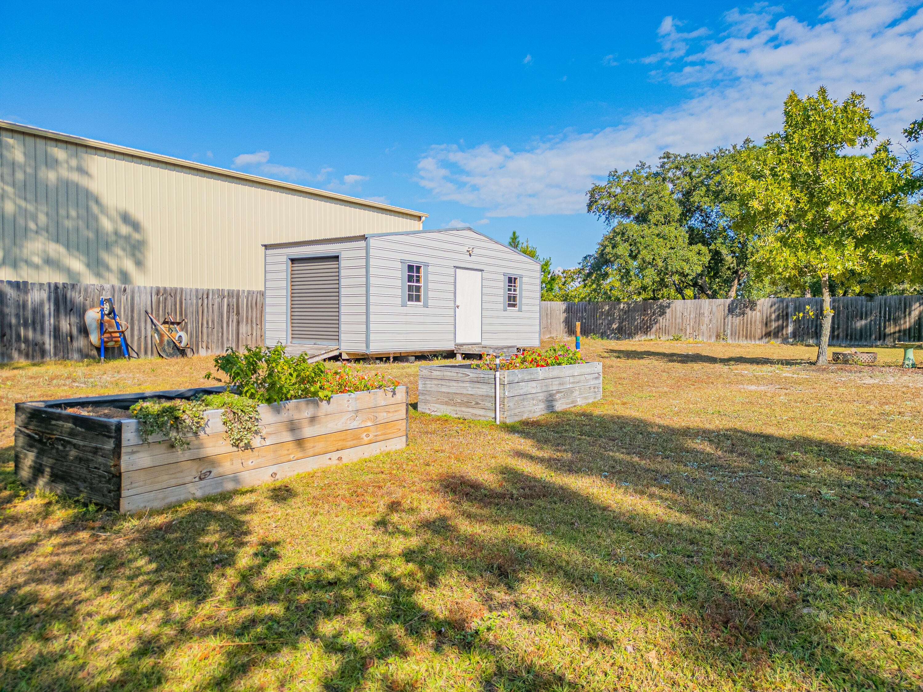 8686 El Paseo Street Navarre, FL 32566 - Photo 34 of 39 a view of swimming pool with lawn chairs and plants