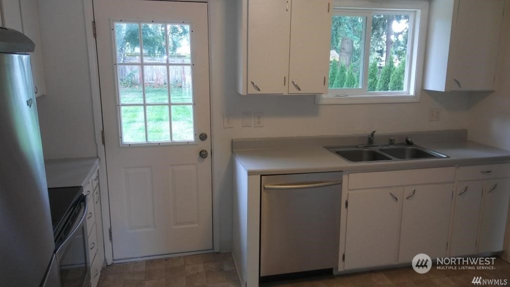 130 Bellflower Road Bothell, WA 98012 - Photo 5 of 25 a kitchen with a sink and cabinets