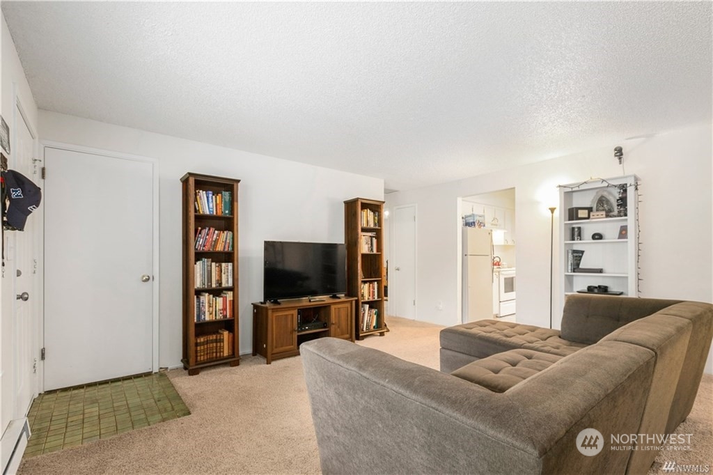 130 Bellflower Road Bothell, WA 98012 - Photo 6 of 25 a living room with furniture and a flat screen tv