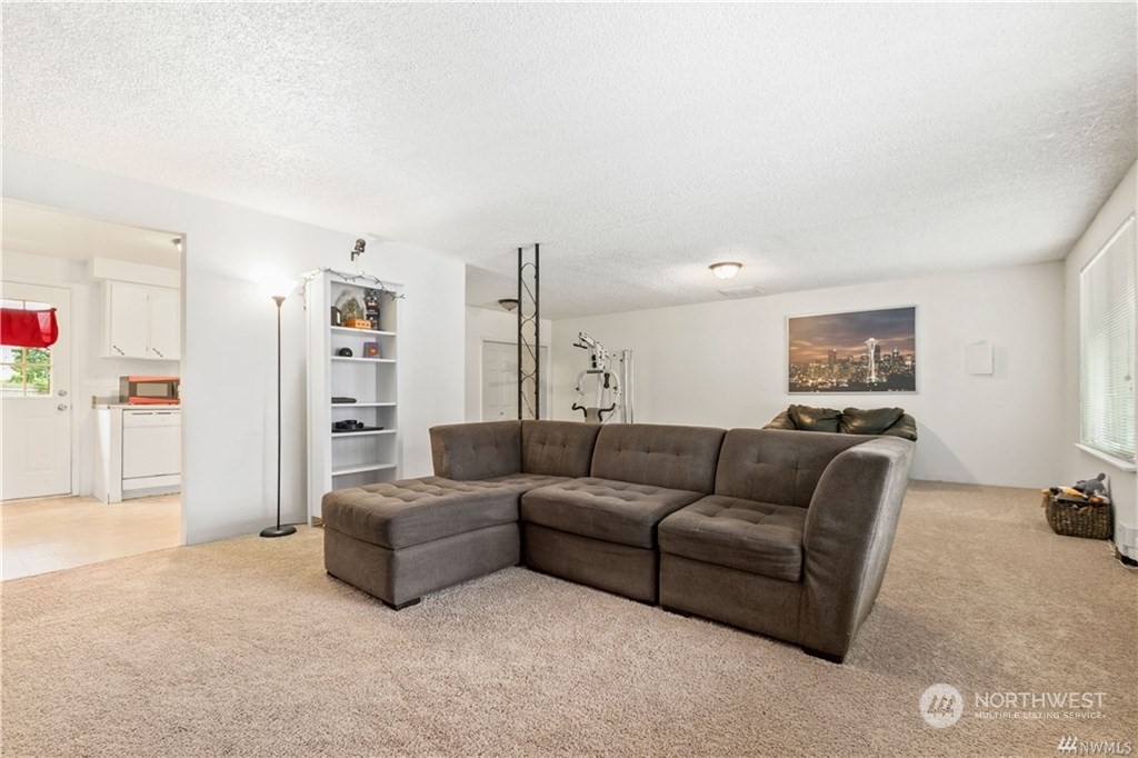 130 Bellflower Road Bothell, WA 98012 - Photo 7 of 25 a living room with furniture and a couch
