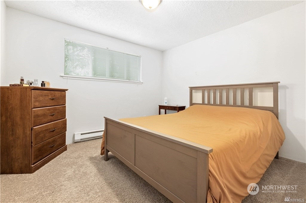 130 Bellflower Road Bothell, WA 98012 - Photo 9 of 25 a bed room with a bed and a dresser
