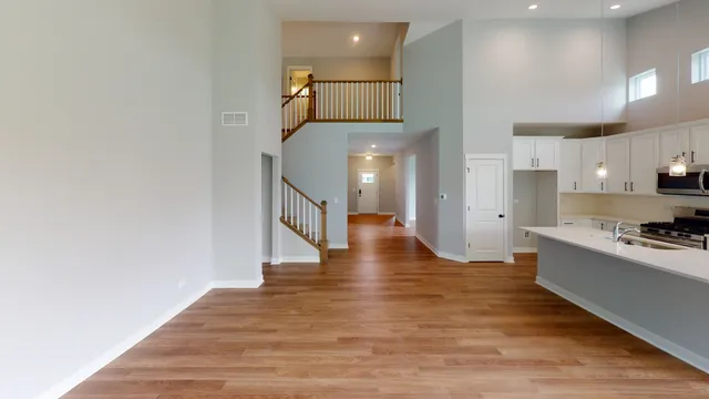 a view of a kitchen with wooden floor and electronic appliances