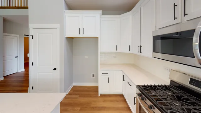 a kitchen with stainless steel appliances a stove and a microwave