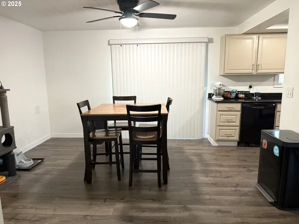 a view of a dining room with furniture and a window
