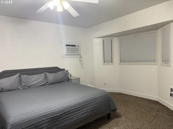 a bedroom with a bed and a table