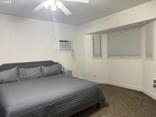 a bedroom with a bed and a table