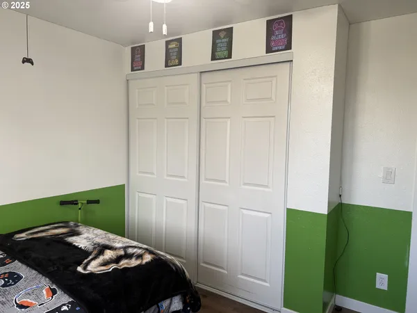 a bedroom with a bed and a dresser