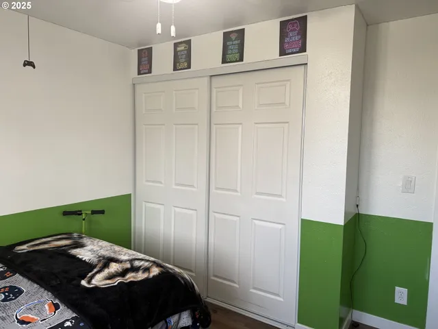 a bedroom with a bed and a dresser