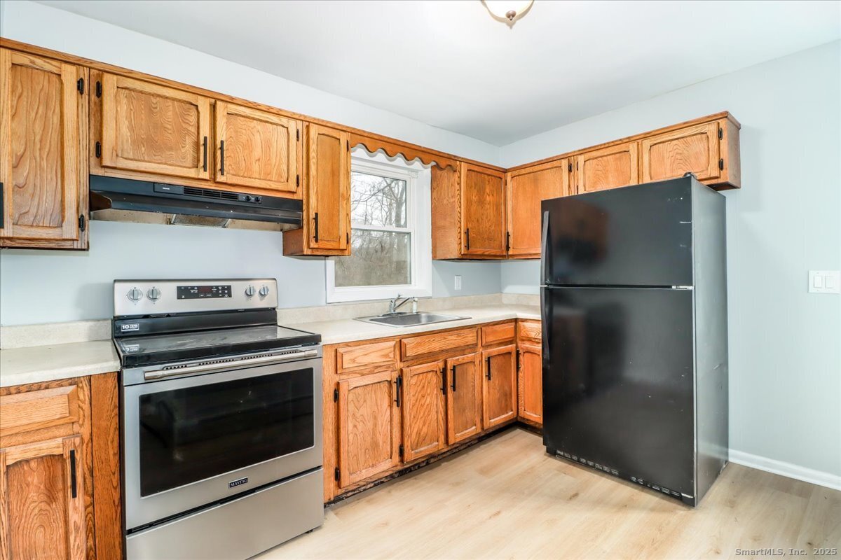 32 Pleasant Street Bethel, CT 06801 - Photo 13 of 29 a kitchen with stainless steel appliances granite countertop a refrigerator stove and sink