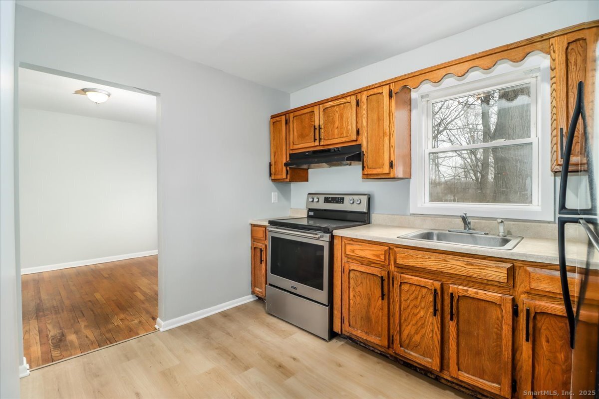 32 Pleasant Street Bethel, CT 06801 - Photo 14 of 29 a kitchen with stainless steel appliances granite countertop a stove a sink and a microwave