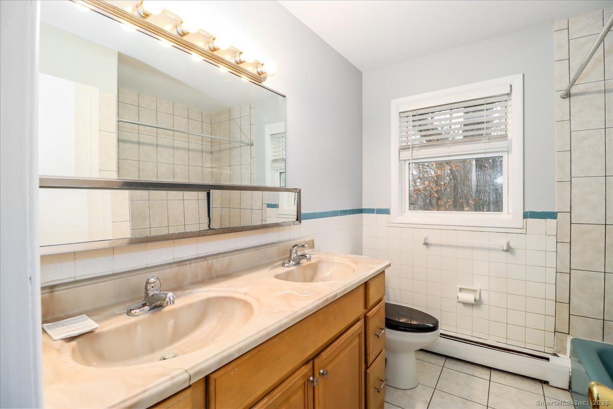 32 Pleasant Street Bethel, CT 06801 - Photo 16 of 29 a bathroom with a sink and a mirror