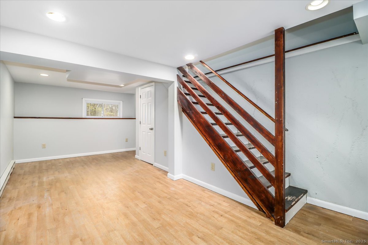 32 Pleasant Street Bethel, CT 06801 - Photo 25 of 29 a view of an empty room with stairs and a ceiling fan