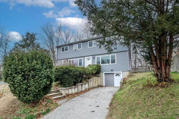 a house that has a tree in front of the house