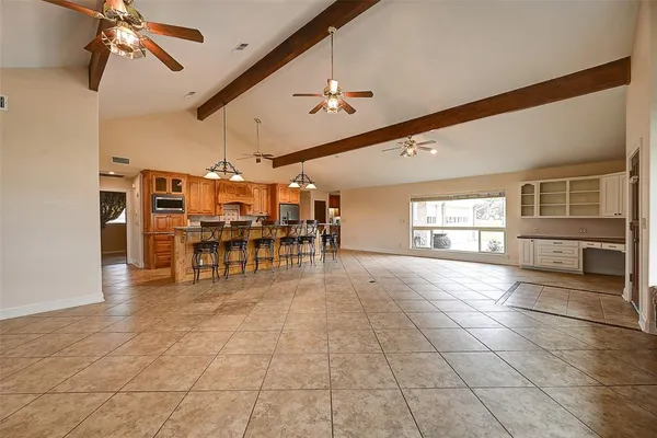 a kitchen with stainless steel appliances a refrigerator and a dining table