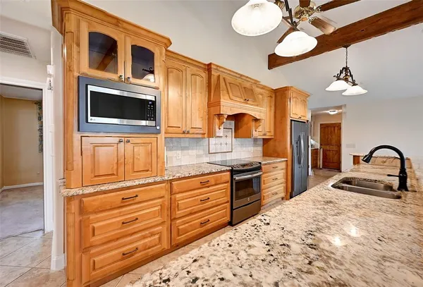 a large kitchen with stainless steel appliances granite countertop plenty wooden cabinets