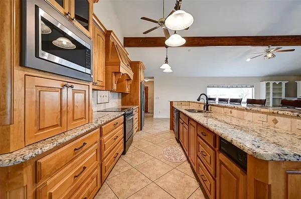 a kitchen with stainless steel appliances granite countertop a refrigerator and a sink
