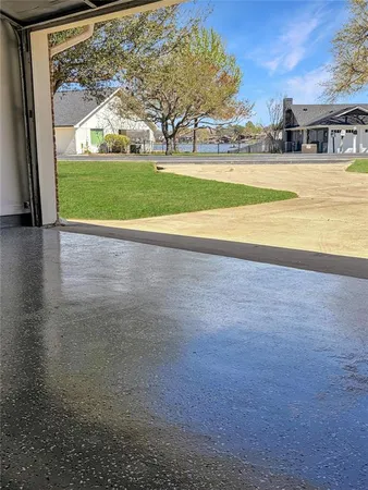 a view of a big house with a big yard and large trees