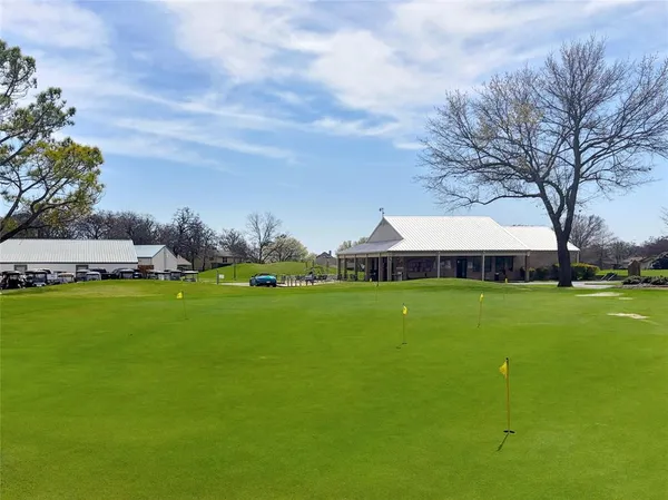 a view of street with houses and trees in the background