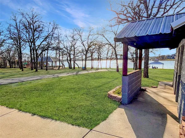 a front view of a house with a yard and car parked