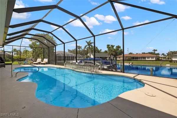 a swimming pool with outdoor seating and yard