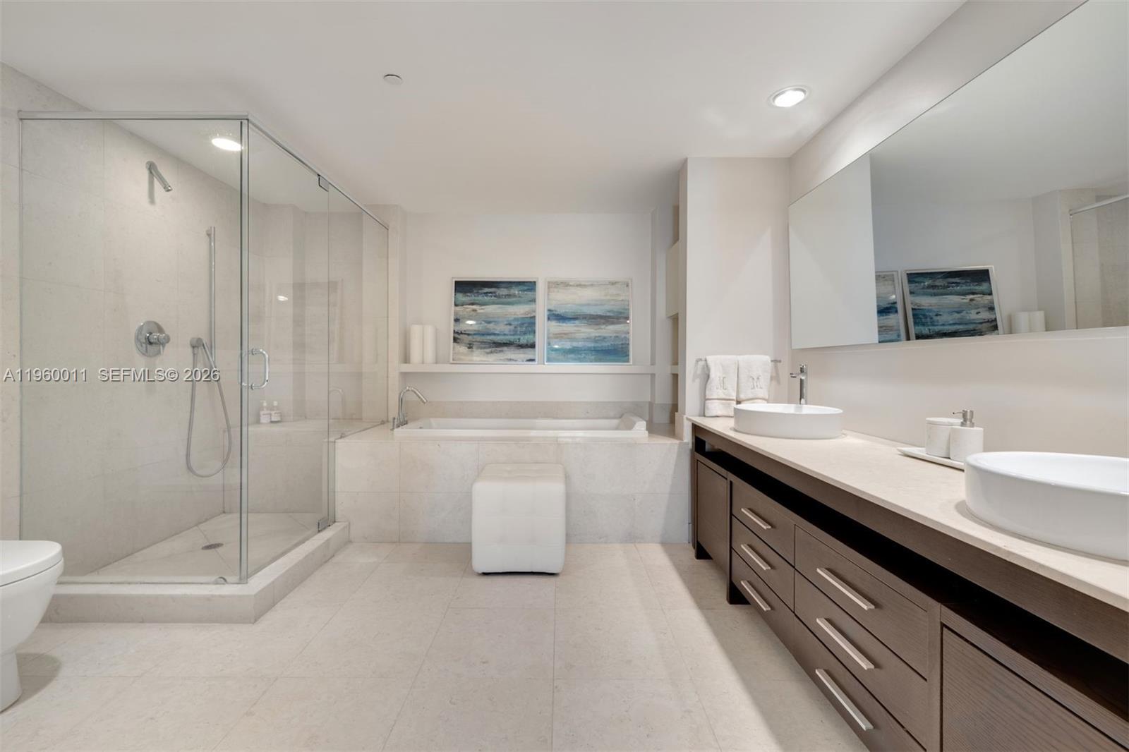 465 Brickell Avenue, Unit 2703 Miami, FL 33131 - Photo 15 of 40 a bathroom with a double vanity sink toilet and shower