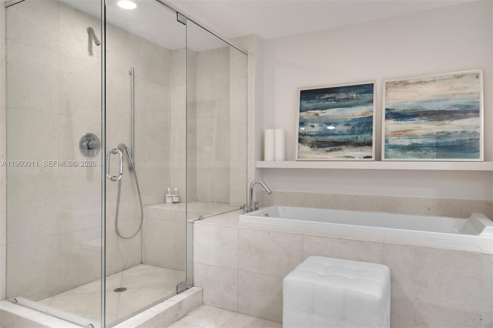 465 Brickell Avenue, Unit 2703 Miami, FL 33131 - Photo 17 of 40 a bathroom with a shower and a bathtub