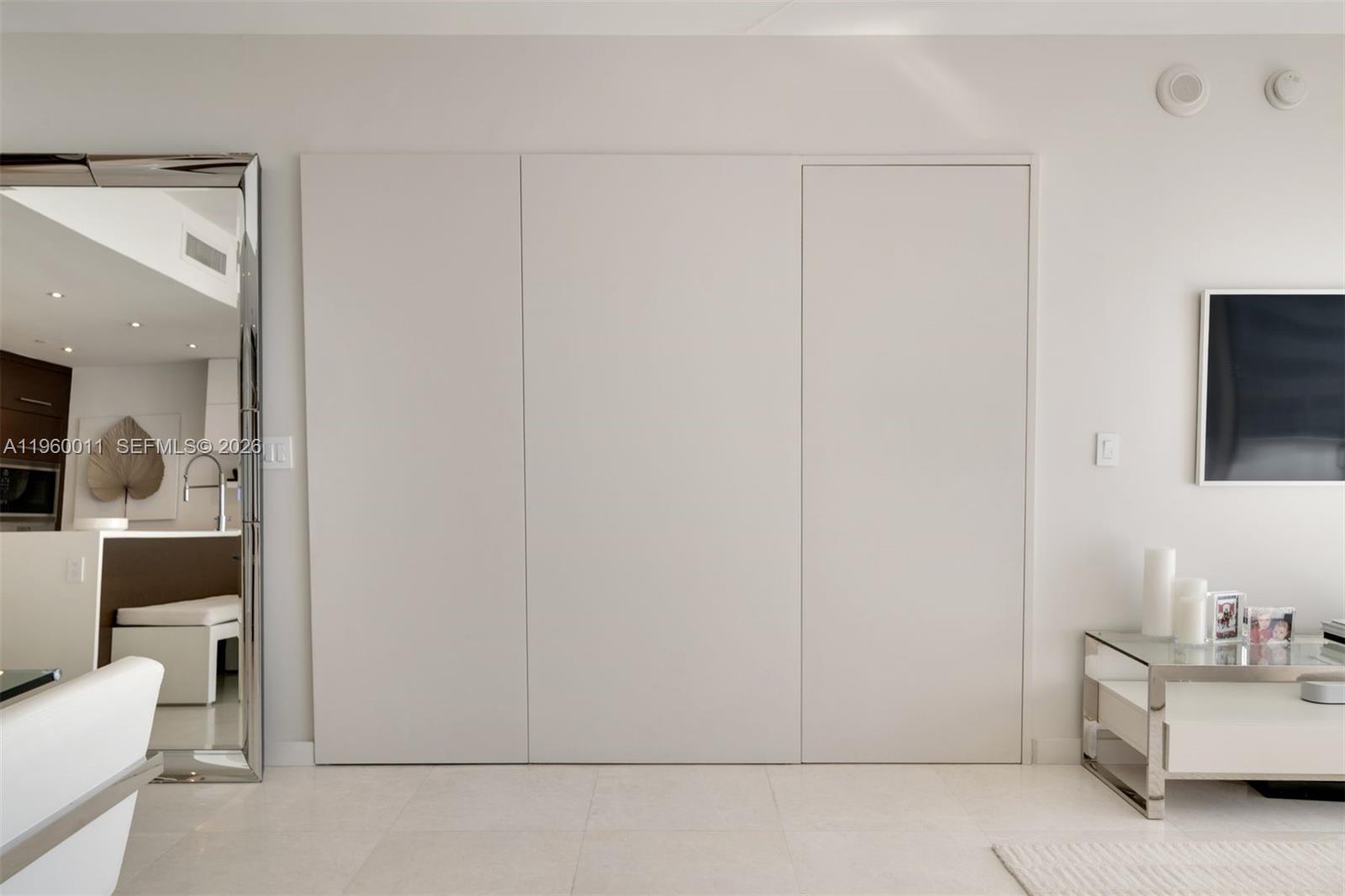 465 Brickell Avenue, Unit 2703 Miami, FL 33131 - Photo 19 of 40 a living room with furniture and a flat screen tv