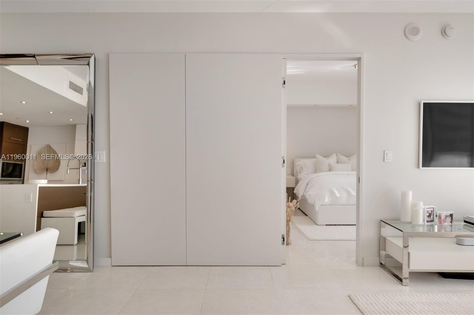 465 Brickell Avenue, Unit 2703 Miami, FL 33131 - Photo 21 of 40 a room with a bed and a mirror