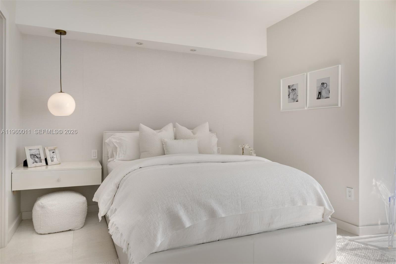 465 Brickell Avenue, Unit 2703 Miami, FL 33131 - Photo 22 of 40 a bedroom with a bed and wall painting