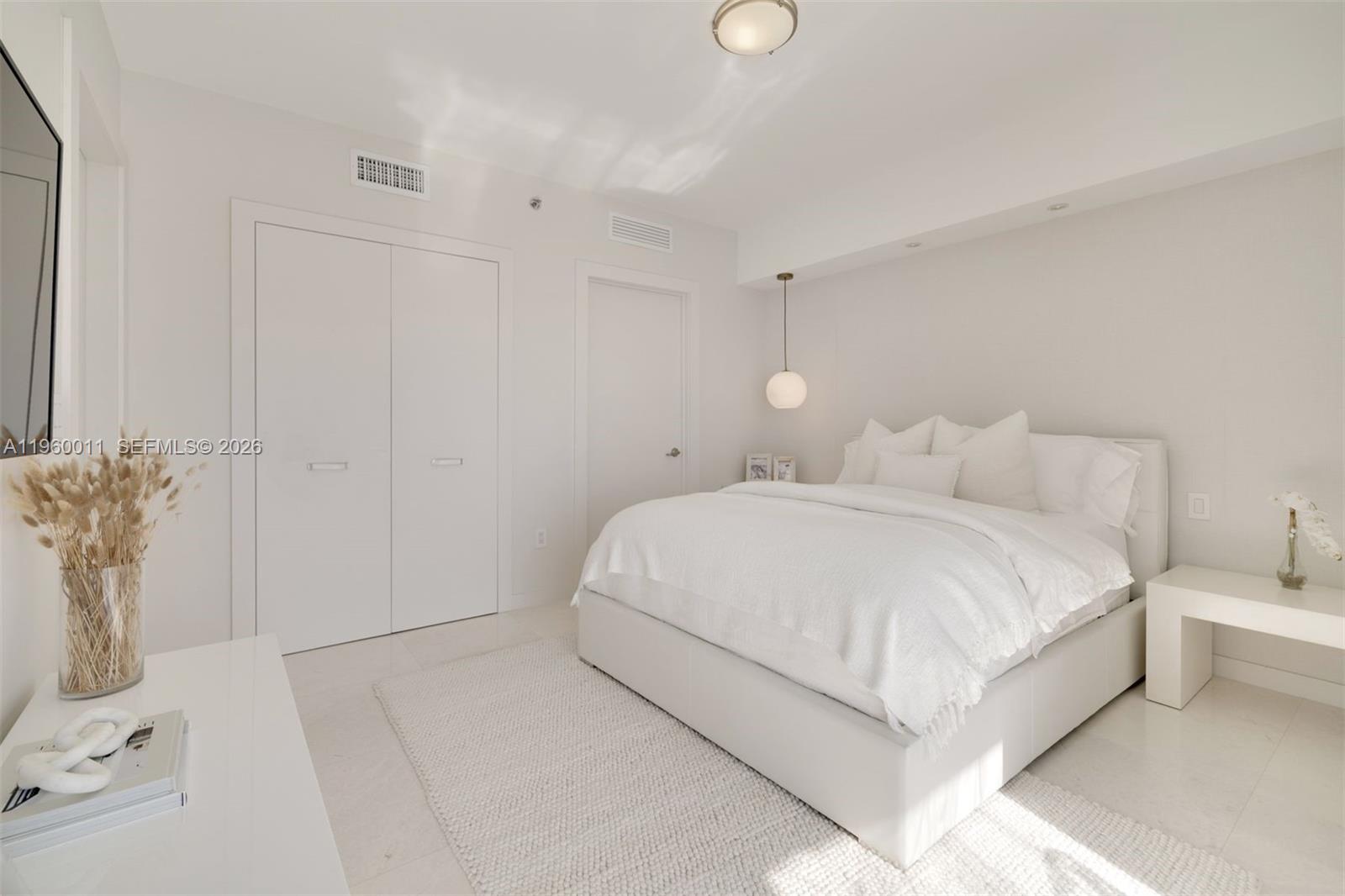 465 Brickell Avenue, Unit 2703 Miami, FL 33131 - Photo 23 of 40 a large white bed in a white room
