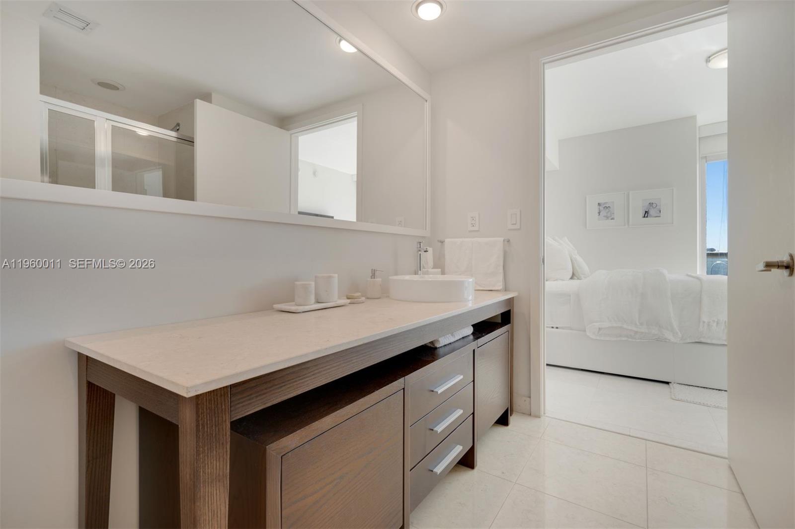 465 Brickell Avenue, Unit 2703 Miami, FL 33131 - Photo 25 of 40 a bathroom with a sink and a mirror