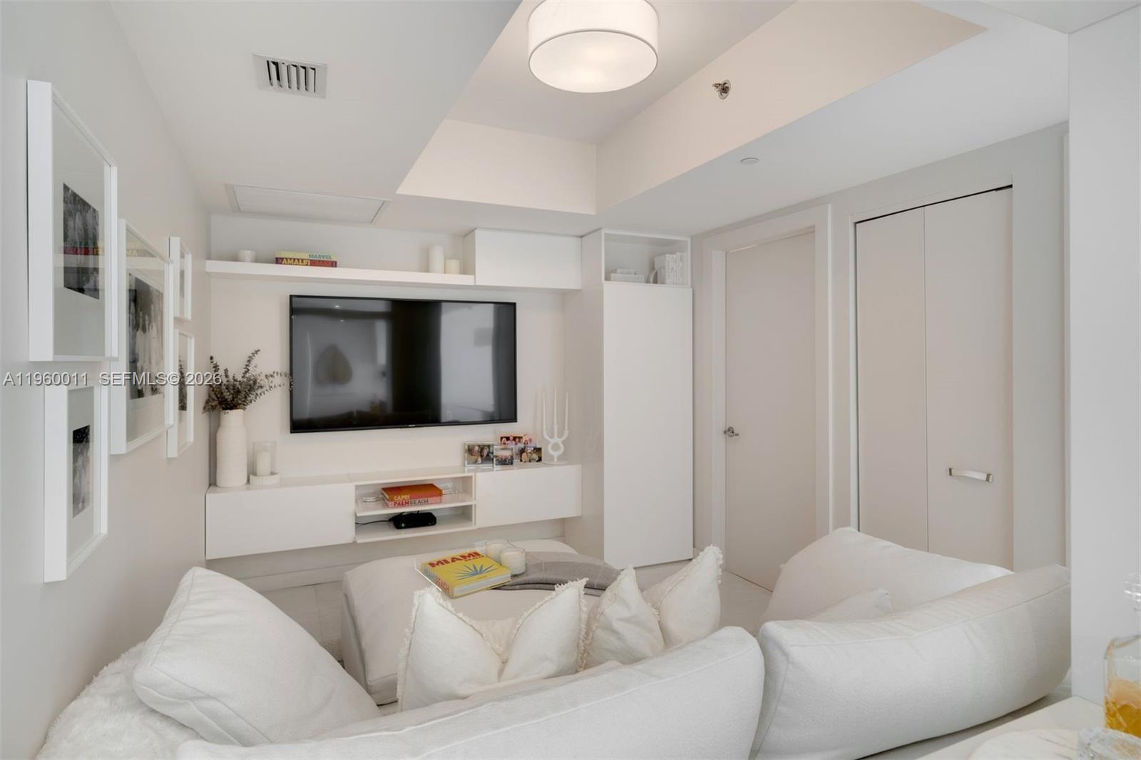 465 Brickell Avenue, Unit 2703 Miami, FL 33131 - Photo 28 of 40 a living room with furniture and a flat screen tv