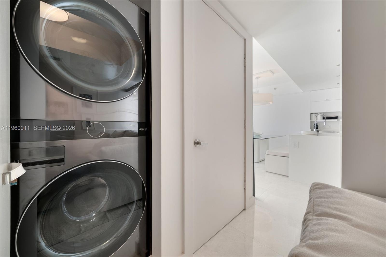 465 Brickell Avenue, Unit 2703 Miami, FL 33131 - Photo 32 of 40 a view of a bedroom with washer and dryer