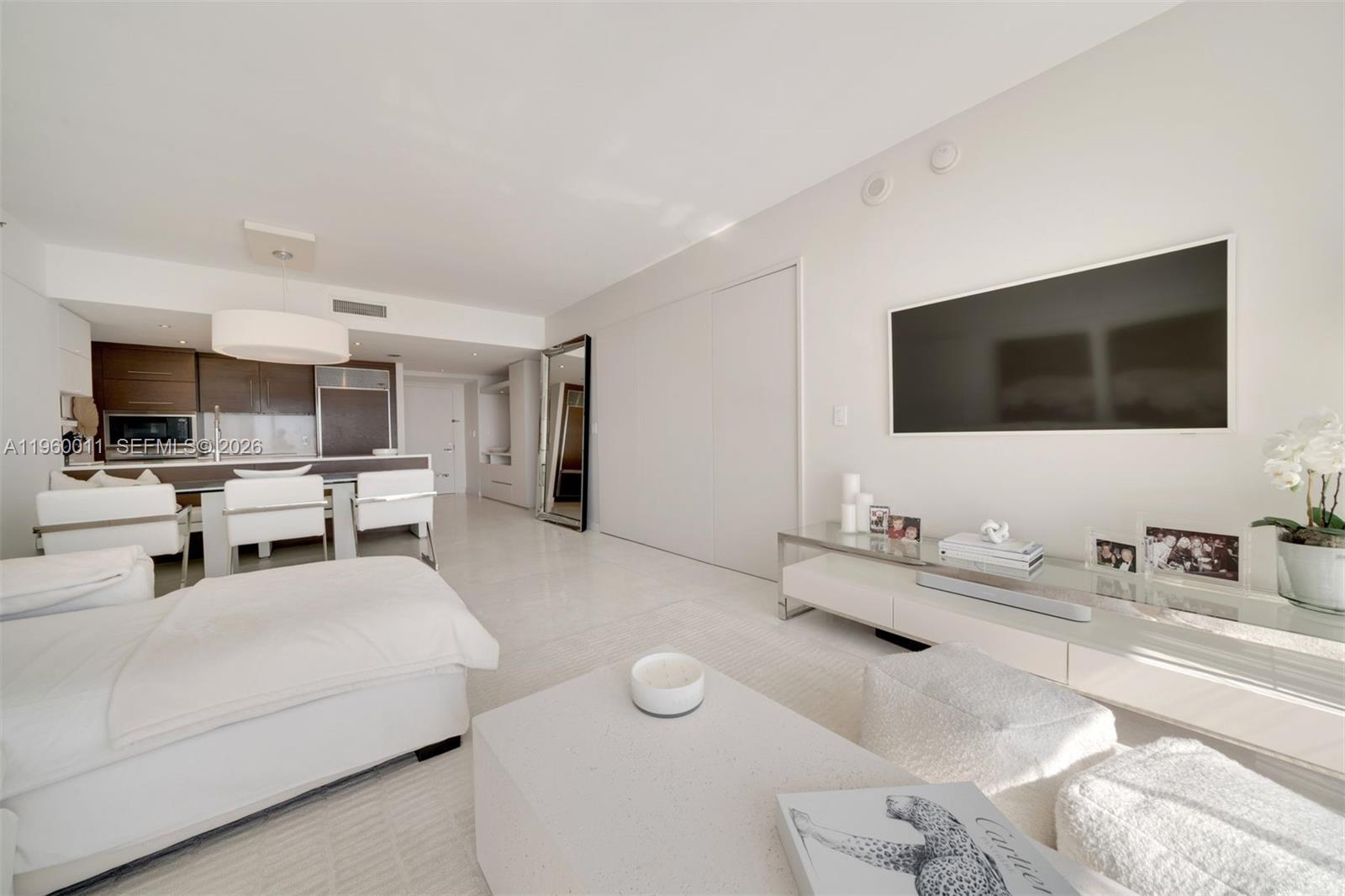 465 Brickell Avenue, Unit 2703 Miami, FL 33131 - Photo 4 of 40 a living room with furniture and a flat screen tv