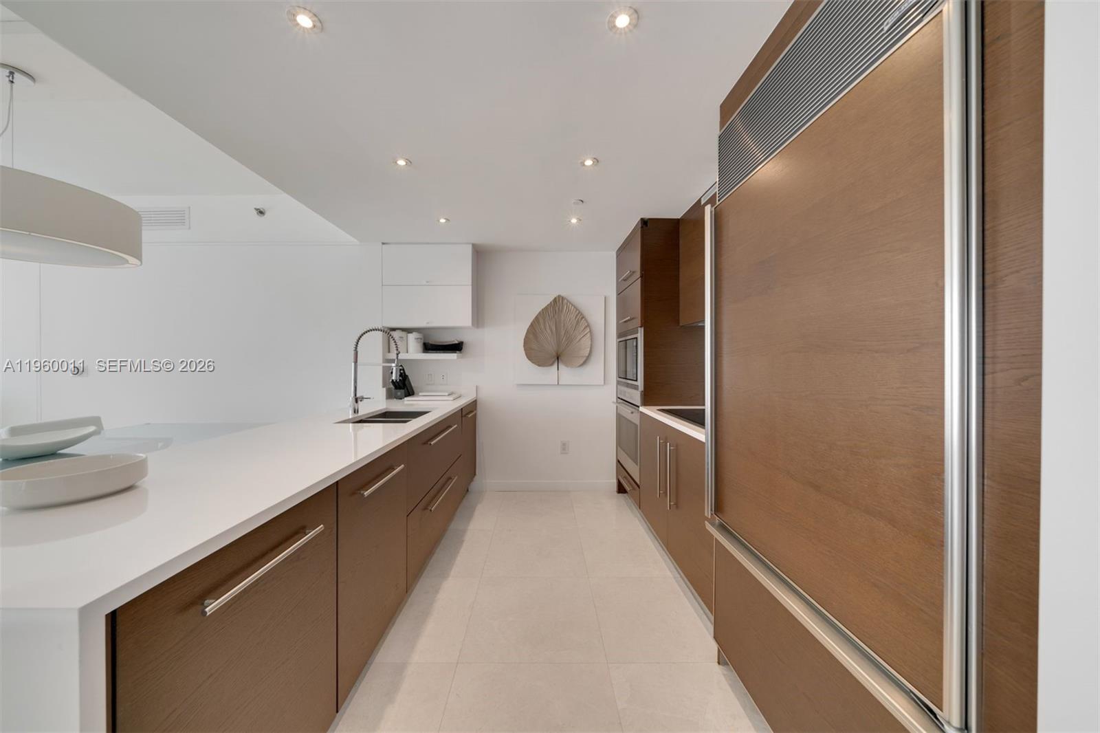 465 Brickell Avenue, Unit 2703 Miami, FL 33131 - Photo 9 of 40 a kitchen with a sink and refrigerator
