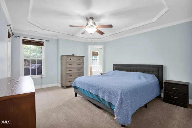 a spacious bedroom with a bed and a dresser