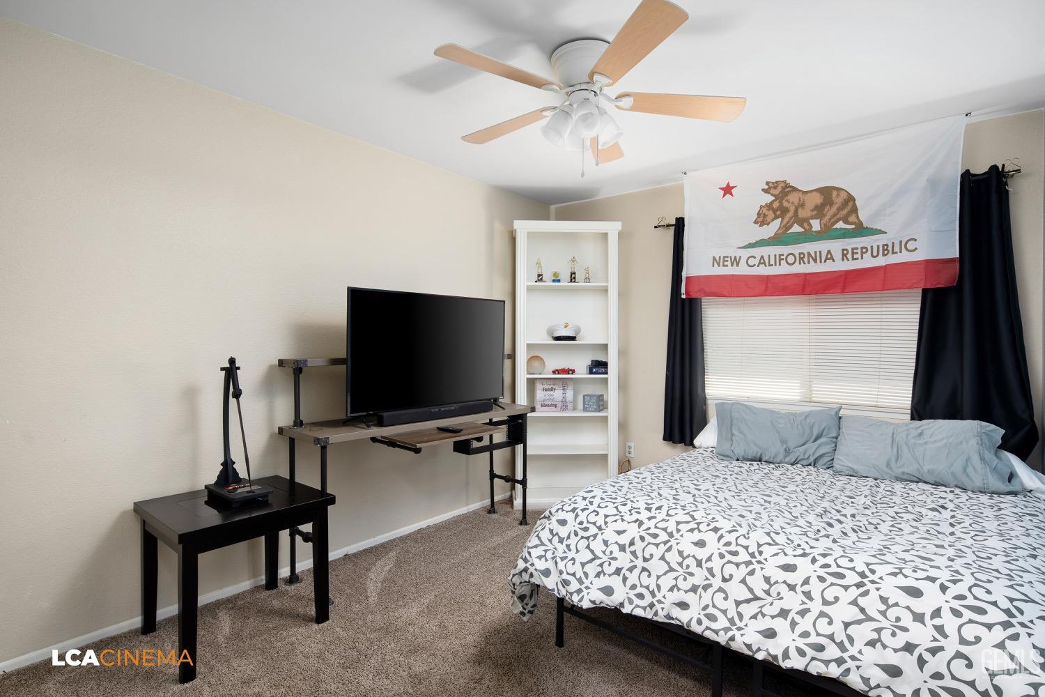 Undisclosed Address Bakersfield, CA 93308 - Photo 11 of 20 a bedroom with a bed and a flat screen tv