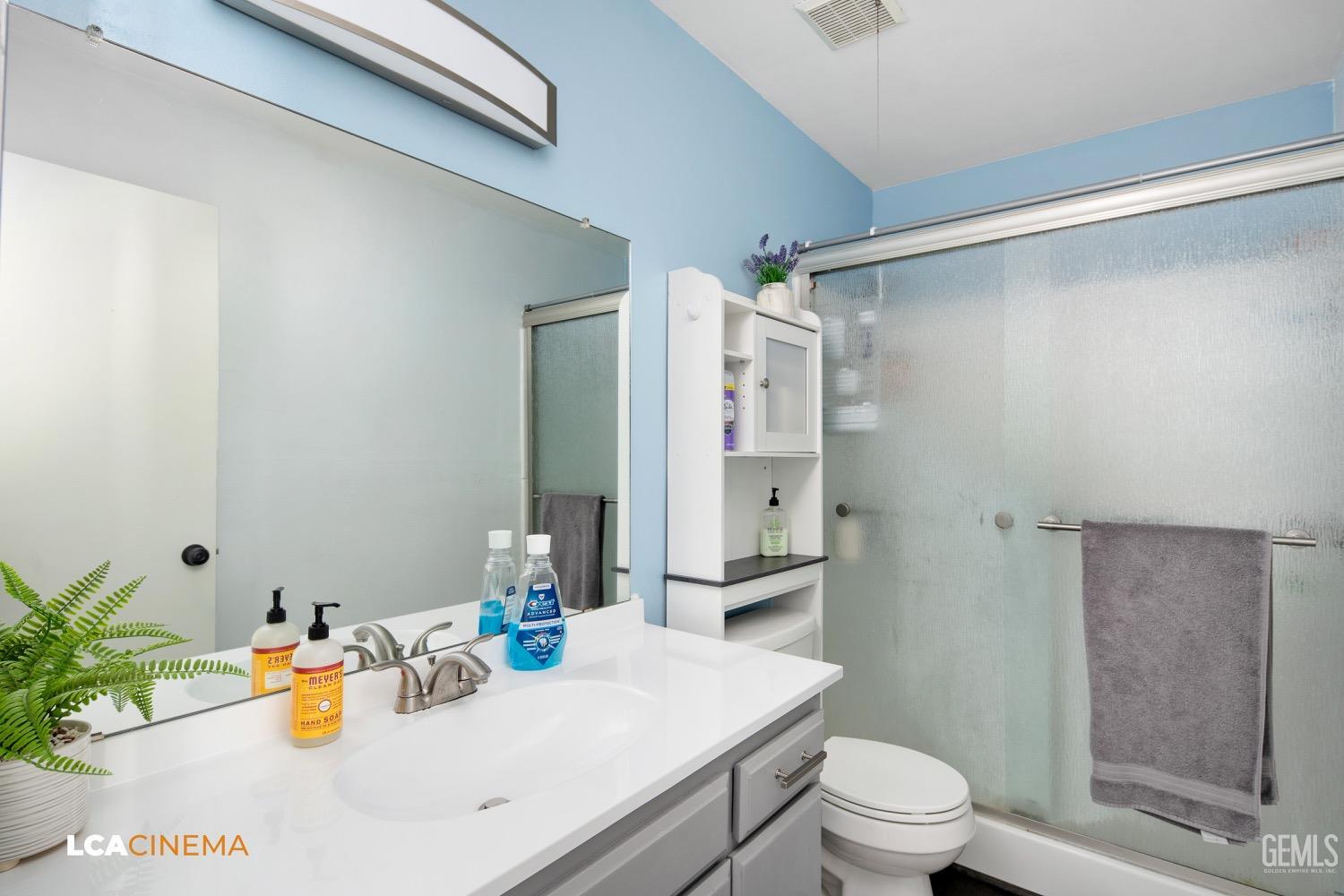 Undisclosed Address Bakersfield, CA 93308 - Photo 12 of 20 a bathroom with a sink mirror vanity and toilet