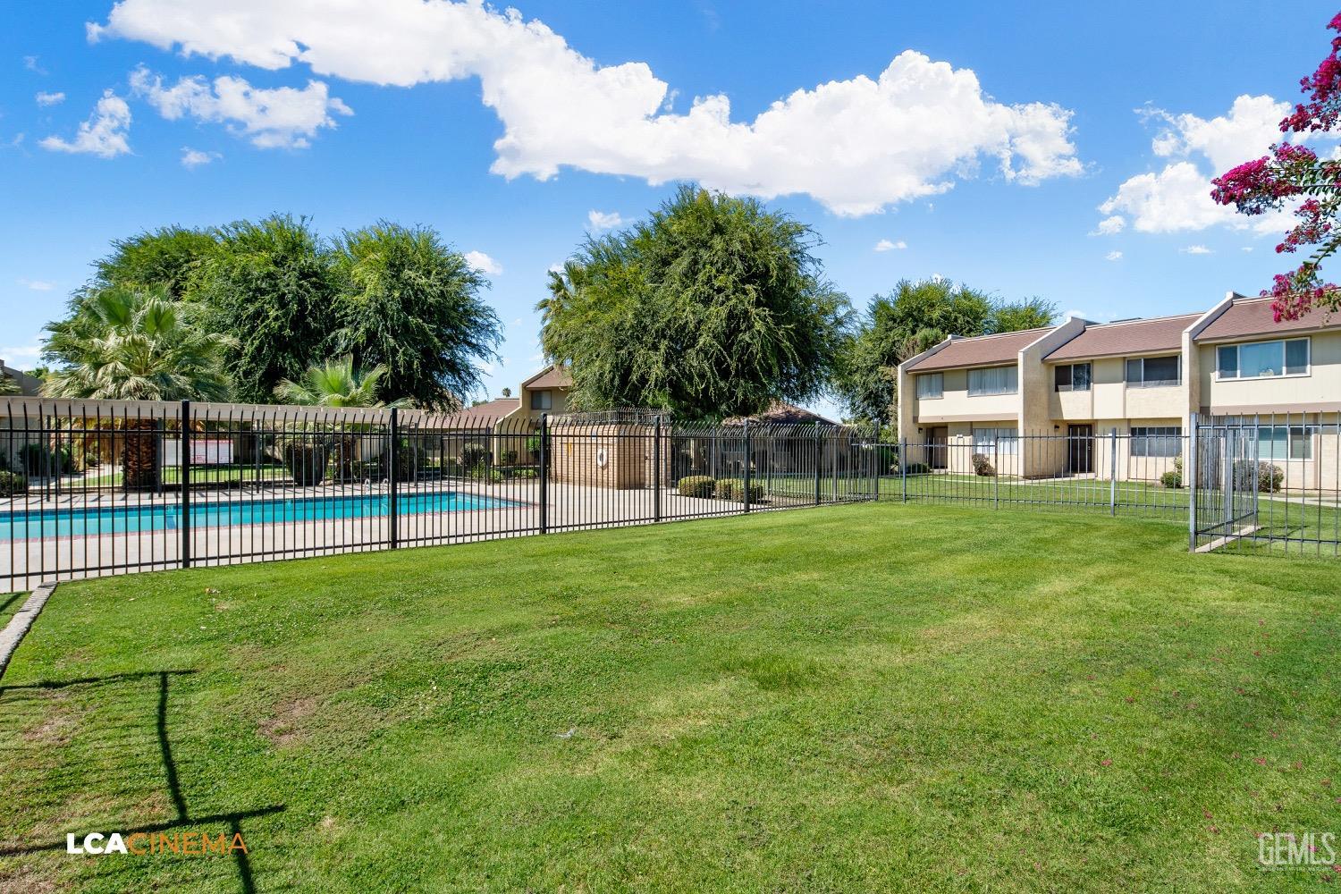 Undisclosed Address Bakersfield, CA 93308 - Photo 16 of 20 a view of a house with a big yard and a large tree