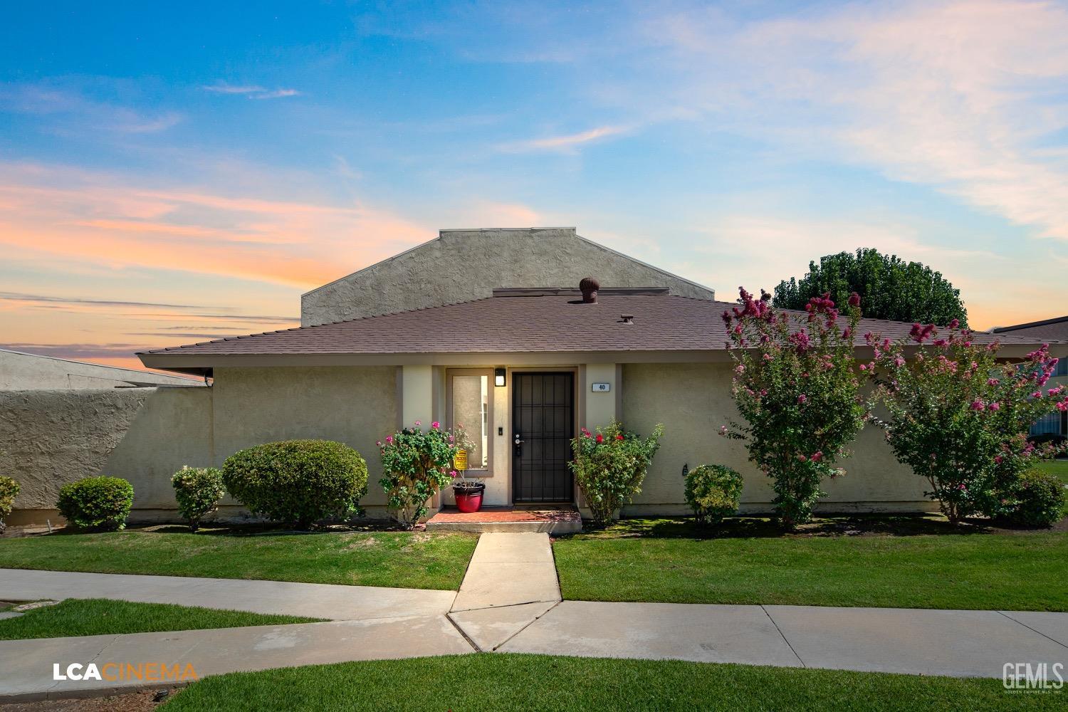 Undisclosed Address Bakersfield, CA 93308 - Photo 2 of 20 a front view of a house with a garden and plants
