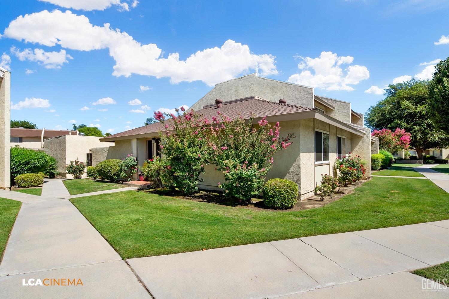 Undisclosed Address Bakersfield, CA 93308 - Photo 3 of 20 a front view of a house with a garden