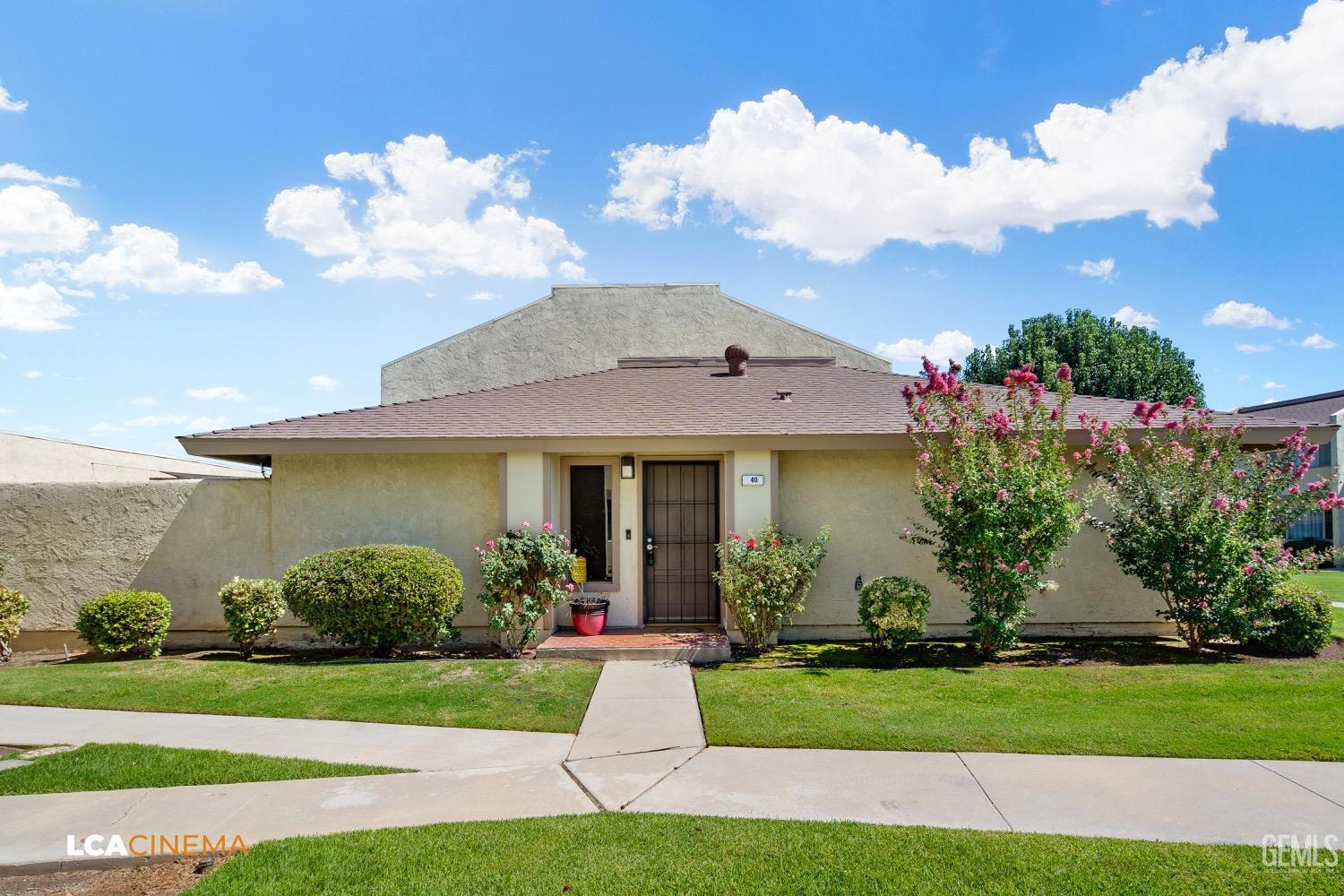 Undisclosed Address Bakersfield, CA 93308 - Photo 4 of 20 a front view of a house with a garden and plants