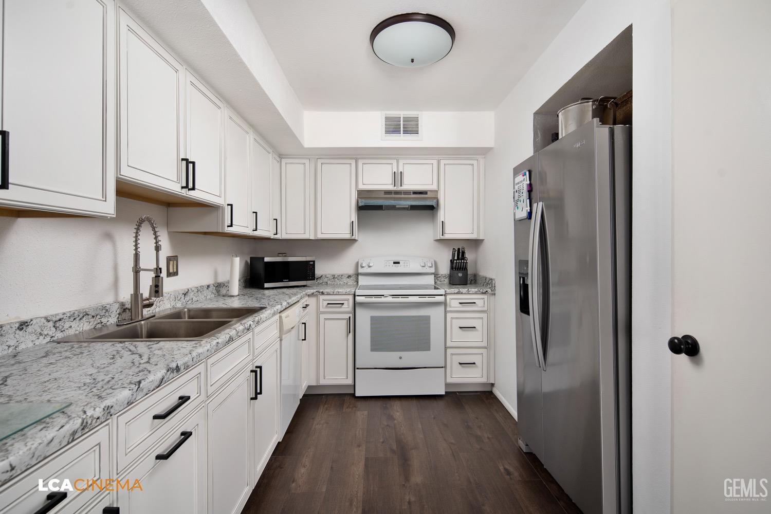 Undisclosed Address Bakersfield, CA 93308 - Photo 6 of 20 a kitchen with stainless steel appliances granite countertop a refrigerator sink and cabinets