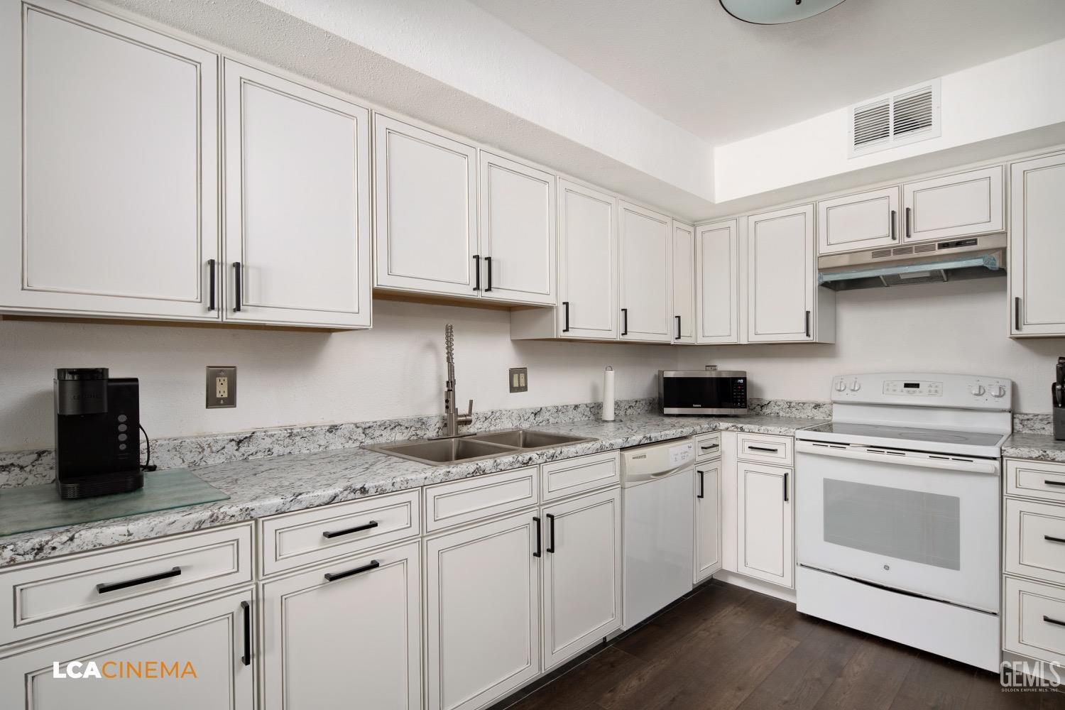 Undisclosed Address Bakersfield, CA 93308 - Photo 7 of 20 a kitchen with stainless steel appliances granite countertop white cabinets sink and dishwasher