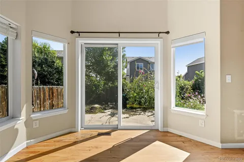 a bedroom with a bed and glass door