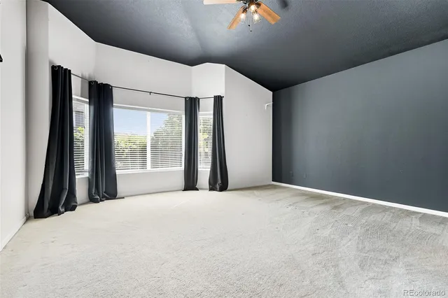 a large bed sitting in a bedroom next to a window